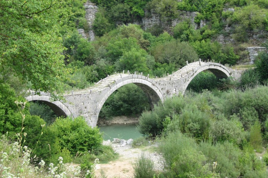 The arched stone bridge at Kipi in Zagori, set among the green hills of Zagorochoria